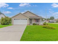 Charming single-story home with a well-manicured lawn, attached garage, and inviting front porch at 441 Plymouth Loop, Longs, SC 29568