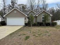 Charming single-story home with a well-manicured front yard and attached two-car garage at 476 Warren Springs Dr., Conway, SC 29527