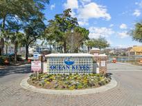 Entrance sign for gated condo community called Ocean Keyes, with beautiful landscaping at 601 Hillside Dr. N # 1823, North Myrtle Beach, SC 29582