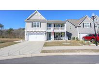 Charming two-story home with a double porch, white trim, and a well-manicured lawn in a Gathering-friendly neighborhood at 780 Old Murrells Inlet Rd., Murrells Inlet, SC 29576