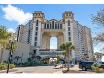 Stunning multi-story building showcasing unique architectural design with arched entrance and ample parking at 100 N Beach Blvd. # 1608, North Myrtle Beach, SC 29582
