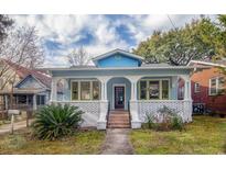 Charming blue house with a welcoming front porch and beautifully landscaped front yard at 1019 Prince St., Georgetown, SC 29440
