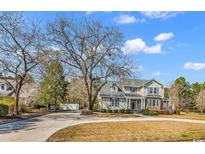 Charming two-story home with manicured landscaping and a circular driveway, offering classic curb appeal at 182 Duck Blind Trail, Myrtle Beach, SC 29588