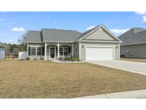 Charming single-story home with a well-maintained lawn, landscaping, and attached two car garage at 211 Copperwood Loop, Conway, SC 29526