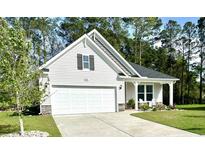 Charming home featuring a two-car garage, neutral siding, and a welcoming front porch at 2441 Capri Court, Conway, SC 29527
