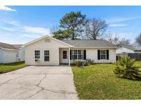 Charming one story home with tidy landscaping, driveway, and neutral siding under a blue sky at 2759 Temperance Dr., Myrtle Beach, SC 29577
