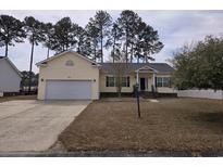 Charming single-story home featuring a well-manicured front yard and attached garage at 323 Stone Throw Dr., Murrells Inlet, SC 29576