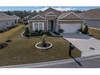 Charming single-story home with manicured lawn, stone accents, and a two-car garage, enhancing curb appeal at 331 Firenze Loop, Myrtle Beach, SC 29579