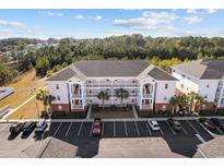 Inviting condo complex featuring a classic facade, convenient parking, and lush landscaping at 4142 Hibiscus Dr. # 104, Little River, SC 29566