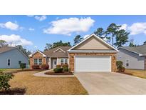 Charming single-story home with brick accents, manicured lawn and attached two-car garage in a desirable community at 494 Battey Dr., Myrtle Beach, SC 29588