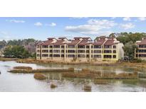 Multi-story waterfront condo building with views of the marsh and natural surroundings at 501 Maison Dr. # F-1, Myrtle Beach, SC 29572