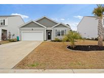 Charming single-story home featuring a one-car garage, landscaped yard, and inviting front entrance at 5064 Wavering Place Loop, Myrtle Beach, SC 29579