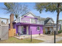 Charming purple home with a white balcony, inviting curb appeal, and landscaped surroundings at 508-B Rosemary Ln., North Myrtle Beach, SC 29582