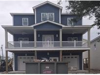 Charming two-story home featuring a covered porch, durable siding, and convenient garage access on the ground level at 510 21St Ave. S, North Myrtle Beach, SC 29582