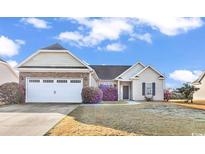 Charming single-story home with a two-car garage and stone detailing at 621 Cottontail Trail, Myrtle Beach, SC 29588