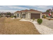 Charming single-story home featuring a two-car garage and beautifully landscaped front yard with white stone accents at 668 Barona Dr., Myrtle Beach, SC 29579