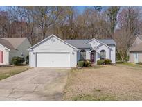 Charming one-story home featuring a two-car garage and manicured lawn at 675 Bluebird Ln., Murrells Inlet, SC 29576