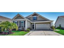 Charming home with well-maintained lawn, neat landscaping, and an attached two-car garage at 808 Yauhannah Dr., Little River, SC 29566