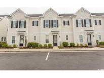 Charming townhome exterior with black shutters, tidy landscaping, and convenient parking in front at 845 Hall Lane # B, Myrtle Beach, SC 29577