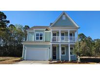 Charming two-story home with light green siding, white trim, and a welcoming front porch at 918 Belle Dr., North Myrtle Beach, SC 29582