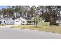 Charming single-story home with a well-manicured front yard, a driveway, and a cozy front porch at 945 Castlewood Dr., Conway, SC 29526