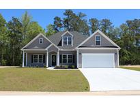 Inviting single-Gathering home featuring a two-car garage, manicured lawn, and classic architectural details at Tbd 10 Saint John Rd., Galivants Ferry, SC 29544