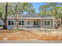 Charming single-story home with neutral siding, white trim, and a welcoming covered front porch at Tbd Old Charleston Rd., Georgetown, SC 29440