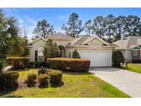 Charming single-story home with manicured landscaping and a two-car garage at 101 Carriage Lake Dr., Little River, SC 29566