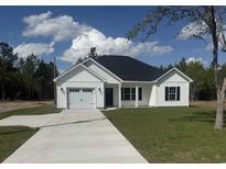 Charming single-story home with a well-manicured lawn, white siding, and an attached two-car garage at 10534 W Highway 19, Loris, SC 29569