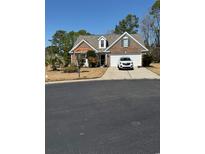 Charming single-story brick home featuring an attached two-car garage and well-maintained landscaping at 1205 Woodruff Ct., Conway, SC 29526