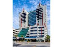 Grand Atlantic Resort exterior shows blue and red accents on a tall, modern building with attached parking garage at 2007 S Ocean Blvd. # 204, Myrtle Beach, SC 29577