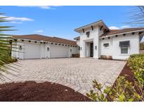 Beautiful home featuring a paved driveway, three-car garage, and pristine white exterior at 2008 Teramo Dr., Myrtle Beach, SC 29579