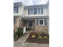 Charming townhome facade featuring brick exterior, blue shutters, and a welcoming porch at 210 25Th Ave. S # 26, Myrtle Beach, SC 29577