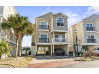 Charming coastal home with covered parking, balconies, and beautiful landscaping including a palm tree at 2304 Pointe Marsh Ln., North Myrtle Beach, SC 29582