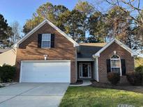 Charming brick home with a well-maintained lawn, two-car garage, and inviting entrance at 280 Barclay Dr., Myrtle Beach, SC 29579