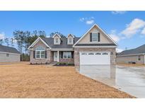 Charming single-Gathering home with brick facade, dormer windows, and a well-manicured lawn at 3325 Hughes Gasque Rd., Aynor, SC 29511