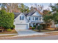 Charming two-story home with white siding, black shutters, manicured landscaping, and an attached two-car garage at 3604 Brampton Dr., Myrtle Beach, SC 29588