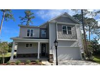 Charming two-story home with a covered front porch, attached garage, and stone accents at 422 Clear Lake Dr., Conway, SC 29526