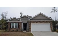 Charming single-story home with stone and siding, complemented by a two-car garage and well-manicured landscaping at 423 Clear Lake Dr., Conway, SC 29526