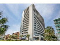 Tall condo building with beachfront views and multiple balconies on a clear, sunny day at 5511 N Ocean Blvd. # 1003, Myrtle Beach, SC 29577