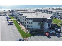 An aerial view of a multi-story condo building with parking and ocean views at 5601 N Ocean Blvd. # B306, Myrtle Beach, SC 29577