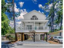Charming two-story coastal home with a covered front porch and spacious ground-level parking at 6001 - 1527 S Kings Hwy., Myrtle Beach, SC 29575