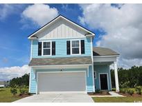 Charming two-story home with light blue siding, white trim, black shutters, and a two-car garage at 8081 Bear Claw Way, Conway, SC 29526