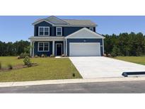Charming two-story home with a blue exterior, a two-car garage, and a well-manicured lawn at 8085 Bear Claw Way, Conway, SC 29526