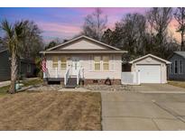 Charming single-story home with a well-manicured lawn and a detached garage at 833 Main Sail Ct., Murrells Inlet, SC 29576