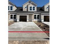New construction townhomes with garages and concrete driveways offer modern living at 2042 Wild Indigo Circle Nw # 204, Calabash, NC 28467