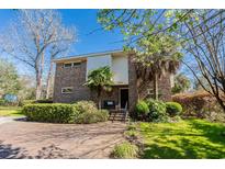 Charming two-story brick home featuring a well-manicured front yard and inviting entryway at 5616 N Kings Hwy., Myrtle Beach, SC 29577