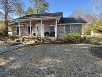 Charming brick home with inviting front porch and classic white columns at 581 Vaux Hall Ave., Murrells Inlet, SC 29576