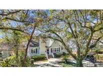 Charming home exterior features a well-manicured lawn, inviting porch, and mature trees, offering curb appeal at 1129 Palmetto St., Georgetown, SC 29440