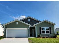 Charming single-story home with green siding, attached garage, well-manicured lawn, and inviting curb appeal at 119 Bolsin Ct, Conway, SC 29526